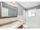 Bathroom with a granite vanity, large mirror, and a shower-tub combination with tiled walls at 12154 E Virginia Dr, Aurora, CO 80012
