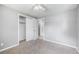 Cozy bedroom with neutral walls, carpet flooring, ceiling fan, and a closet for storage at 12154 E Virginia Dr, Aurora, CO 80012