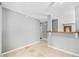 Open dining area with neutral walls and tile flooring, adjacent to a bar and view of entry at 12154 E Virginia Dr, Aurora, CO 80012