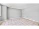 Simple living space with neutral walls, tile flooring, and ample natural light from a window at 12154 E Virginia Dr, Aurora, CO 80012