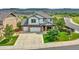 Two-story house with a three-car garage and landscaped yard at 2314 Fairway Wood Cir, Castle Rock, CO 80109