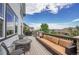 Expansive back deck featuring a dining table, plush outdoor seating, and views of the surrounding neighborhood at 2314 Fairway Wood Cir, Castle Rock, CO 80109