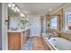 Elegant bathroom with double sinks, soaking tub, and walk-in shower at 2314 Fairway Wood Cir, Castle Rock, CO 80109