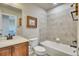 Cozy bathroom featuring a shower-tub combo with tile surround, framed art, and wood vanity at 2314 Fairway Wood Cir, Castle Rock, CO 80109