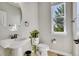 Bright bathroom featuring a pedestal sink, toilet, neutral wall color, and a window for natural light at 2314 Fairway Wood Cir, Castle Rock, CO 80109