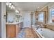 Bathroom with dual vanities, a soaking tub, a separate shower, and tile flooring at 2314 Fairway Wood Cir, Castle Rock, CO 80109