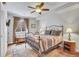 Cozy bedroom features a metal frame bed, patterned rug, natural light from window, and warm lighting at 2314 Fairway Wood Cir, Castle Rock, CO 80109