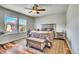 Comfortable bedroom featuring hardwood floors, large windows, and a ceiling fan at 2314 Fairway Wood Cir, Castle Rock, CO 80109