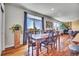 Bright dining room features a rustic wooden table and chairs, with access to a deck overlooking scenic views at 2314 Fairway Wood Cir, Castle Rock, CO 80109