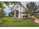 Exterior of the home showcasing a large yard with mature trees and outdoor living spaces at 2314 Fairway Wood Cir, Castle Rock, CO 80109