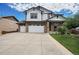 Two-story home with stone accents and a three-car garage at 2314 Fairway Wood Cir, Castle Rock, CO 80109