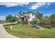 Landscaped yard with mature trees and a large driveway at 2314 Fairway Wood Cir, Castle Rock, CO 80109