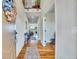 Inviting hallway featuring hardwood floors, neutral walls, and stylish decor leading to other areas of the home at 2314 Fairway Wood Cir, Castle Rock, CO 80109