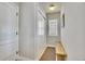 Bright hallway with neutral walls, a storage closet, a window with blinds, and a bench at 2314 Fairway Wood Cir, Castle Rock, CO 80109