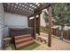 Outdoor hot tub area featuring a wooden pergola, providing a private and relaxing retreat at 2314 Fairway Wood Cir, Castle Rock, CO 80109