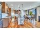 Spacious kitchen with wooden cabinets, hardwood floors, a large island, and stainless appliances at 2314 Fairway Wood Cir, Castle Rock, CO 80109