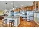 Gourmet kitchen featuring granite countertops, stainless steel appliances, and wood flooring at 2314 Fairway Wood Cir, Castle Rock, CO 80109