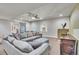 Spacious living room with a large sectional sofa, ceiling fan, barn door, and media cabinet at 2314 Fairway Wood Cir, Castle Rock, CO 80109