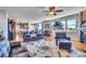 Open concept living room with leather furniture, a fireplace and views into kitchen at 2314 Fairway Wood Cir, Castle Rock, CO 80109