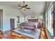 Bright main bedroom featuring vaulted ceiling, hardwood floors, and large windows to backyard at 2314 Fairway Wood Cir, Castle Rock, CO 80109