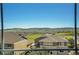 Picturesque window view of the city, mountains, and green fields, showcasing the property's desirable location at 2314 Fairway Wood Cir, Castle Rock, CO 80109