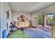 Bright workout room with fitness equipment, storage, and a glass sliding door leading to an outdoor space at 2314 Fairway Wood Cir, Castle Rock, CO 80109