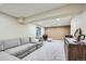 Bright basement with large sectional, a decorative accent cabinet, and recessed lighting at 12282 Bannock Cir # A, Denver, CO 80234