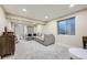 Spacious basement featuring neutral paint, large sectional sofa, and a stylish accent cabinet at 12282 Bannock Cir # A, Denver, CO 80234