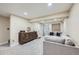 Cozy basement featuring neutral paint, large sectional sofa, and stylish storage console at 12282 Bannock Cir # A, Denver, CO 80234
