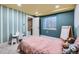 ' bedroom featuring striped accent wall and a bright window with basement access at 12282 Bannock Cir # A, Denver, CO 80234