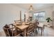 Dining room features a wooden table with woven chairs and bench seating under a woven pendant light at 12282 Bannock Cir # A, Denver, CO 80234