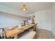 Dining room with a wooden table set for a meal, complemented by woven chairs, bench, and a pendant light at 12282 Bannock Cir # A, Denver, CO 80234