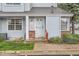 Close up view of townhome with light blue siding, brick accents, and a inviting front door at 12282 Bannock Cir # A, Denver, CO 80234