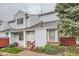 Charming two-story townhome with light blue siding, well-maintained landscaping, and a welcoming entrance at 12282 Bannock Cir # A, Denver, CO 80234