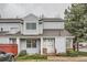 Charming two-story townhome with light blue siding, well-maintained landscaping, and a welcoming entrance at 12282 Bannock Cir # A, Denver, CO 80234