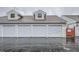 Row of garages on a rainy day; each is lettered and attached to adjacent property at 12282 Bannock Cir # A, Denver, CO 80234