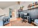 Bright home office with hardwood flooring, built-in bookshelves, and a comfortable chair at 12282 Bannock Cir # A, Denver, CO 80234