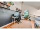 Bright home office featuring built-in bookshelves, hardwood floors, and a comfortable workspace at 12282 Bannock Cir # A, Denver, CO 80234