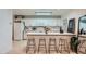 Bright kitchen featuring white cabinets, modern appliances, an island with barstool seating, and stylish decorative touches at 12282 Bannock Cir # A, Denver, CO 80234