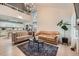 Open-concept living space featuring vaulted ceilings, hardwood floors, and stylish modern furniture at 12282 Bannock Cir # A, Denver, CO 80234
