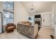 Bright living room featuring a fireplace, large window, and stylish furnishings perfect for relaxation and entertaining at 12282 Bannock Cir # A, Denver, CO 80234