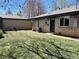 Well-maintained backyard featuring a lush green lawn and brick exterior at 2804 N Harrison St, Denver, CO 80205