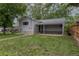 Home's backyard features established green grass, a covered carport, and alley access at 3256 S Ogden St, Englewood, CO 80113
