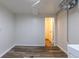 This is a partially finished basement area with vinyl floors and white walls at 3256 S Ogden St, Englewood, CO 80113