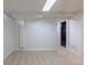 Finished basement area with neutral carpet, bright lighting, and access to additional rooms at 3256 S Ogden St, Englewood, CO 80113