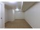 Finished basement space with neutral carpet, paneled walls, closet, and bright overhead lighting at 3256 S Ogden St, Englewood, CO 80113