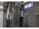 Close up view of home's utility equipment, including water heater and HVAC, located in unfinished basement at 3256 S Ogden St, Englewood, CO 80113