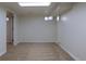Finished basement area features neutral carpet, bright lighting, and access to additional storage and rooms at 3256 S Ogden St, Englewood, CO 80113