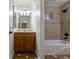 This bathroom offers a bath and shower combination with a modern vanity and tiled flooring at 3256 S Ogden St, Englewood, CO 80113