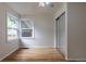 Bright bedroom featuring hardwood floors, a mirror closet, and natural light at 3256 S Ogden St, Englewood, CO 80113